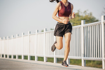 Young woman running in the nature. Healthy lifestyle and sport concepts.  Runner training in a...