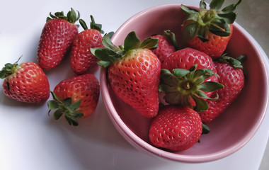 strawberries in a  pink bowl