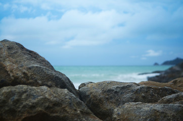 Fototapeta na wymiar Rocks in the beach on blue sky background