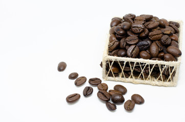 Coffee beans in a basket on white background