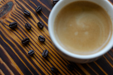 Coffee glass and coffee beans On dark wood floors