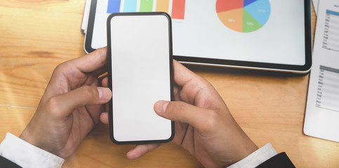 Businessman's hand holding blank screen smartphone