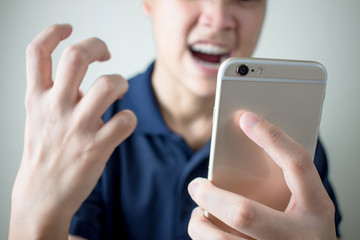 The young man felt angry from the smartphone with problems or errors.