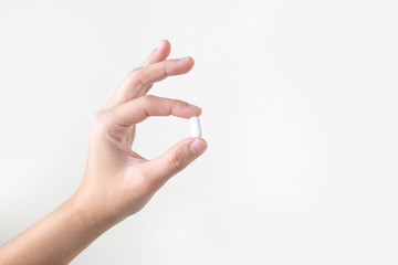 Asian hands are holding white medicine on the white blackground.