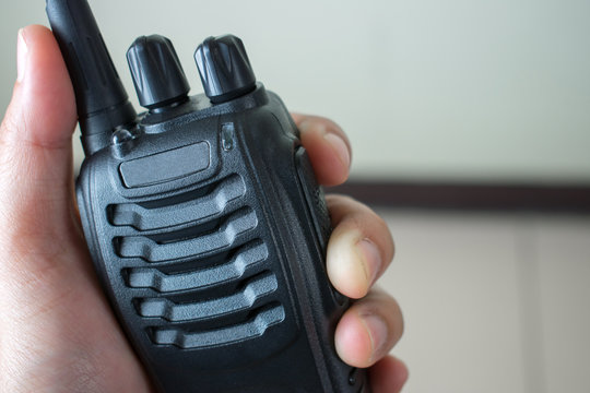 Hand holding radio communication, close up.