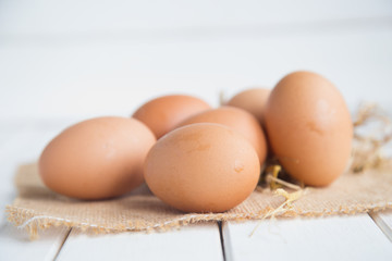 Eggs chicken on white wood background