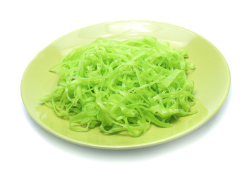 green noodles on dish isolated on white background
