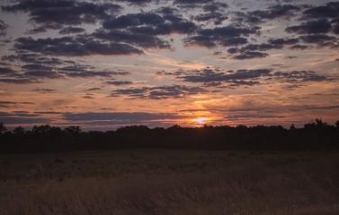 Beautiful Clouds and sunset over open farmland. 