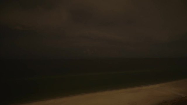 Time Lapse of lightning rolling through the clouds over the ocean.