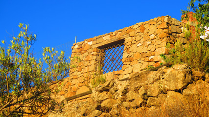 Granite block wall with iron barred window