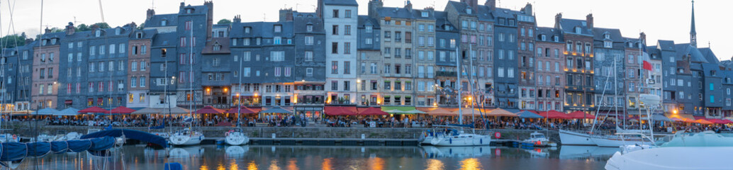 Honfleur, France - 06 01 2019: Panoramic view of the harbor at sunset