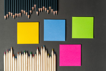 pencils in white and black with multicolored scrapbook. Mock up, copy space. Office or business planning topic, creativity, ideas, variability. Stationery set.