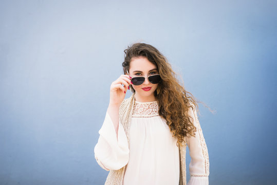 curly haired young woman with sunglasses