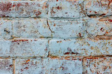 Texture of a brick wall with cracks and scratches which can be used as a background