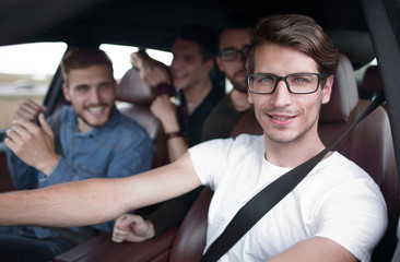 Close up side portrait of happy man driving car