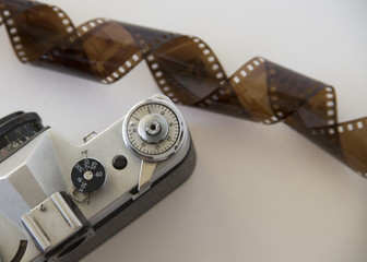 old camera and film on white background