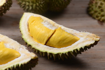 Durian riped and fresh ,durian peel with yellow colour on wooden table.