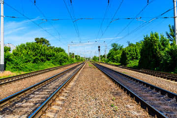 View on a railroad track and white clouds in blue sky