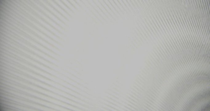 Two pieces of printed plastic sheets forming abstract moir&eacute; patterns. Static wide shot.