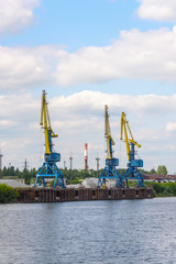 Russia, Moscow August 2018: Unloading of the barge with crushed stone port cranes in the port.