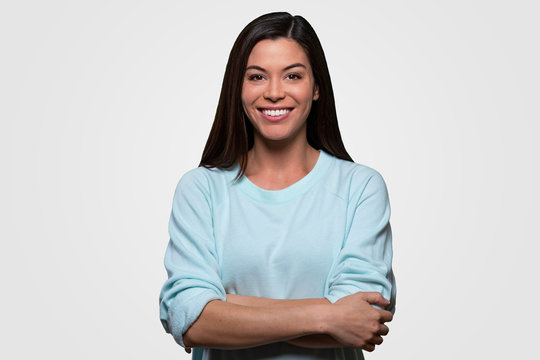 Proud confident woman smiling, happy, cheerful, arms folded, isolated portrait