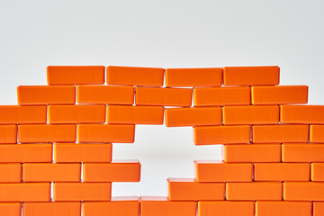 Obraz premium White hole in a brick wall. Frame of Toy block in shape of brick