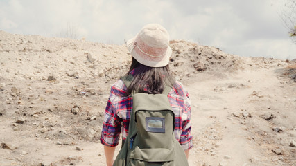 Hiker Asian backpacker woman walking to top of mountain, Female enjoy her holidays on hiking adventure feeling freedom. Lifestyle women travel and relax in free time concept.