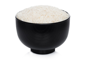 Black bowl of raw organic basmati rice on white background. Healthy food.