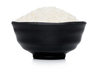 Black bowl of raw organic basmati rice on white background. Healthy food.