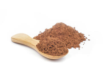 Cocoa in a wooden spoon with cocoa powder isolated on white background.