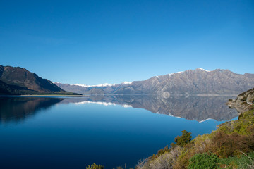 Naklejka na ściany i meble Stunning nature scenery of a beautiful lake nestled under the Southern Alps in New Zealand