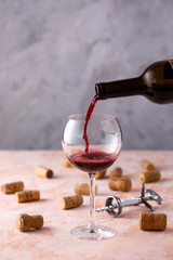 Red wine is poured into a glass. The concept of winemaking. Place under your text.