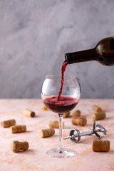 Red wine is poured into a glass. The concept of winemaking. Place under your text.