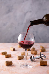 Red wine is poured into a glass. The concept of winemaking. Place under your text.