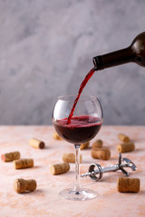 Red wine is poured into a glass. The concept of winemaking. Place under your text.