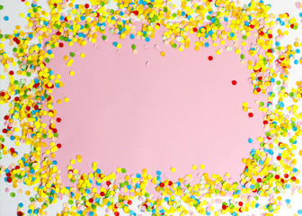 Confetti scattered in different colors on the white background. Festive confetti. The decor for the party.