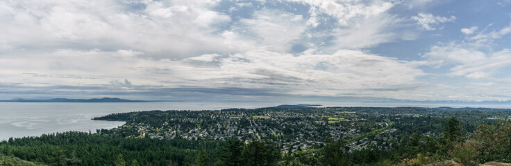Fototapeta premium Aerial panoramic view of the city of Victoria from mount Douglas park with a beautiful Pacific Ocean scene.