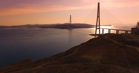 Air review of the Russian bridge on the background of the sea landscape.