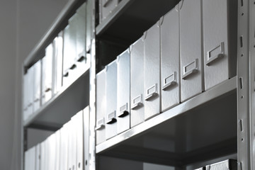 Folders with documents on shelves in archive - obrazy, fototapety, plakaty