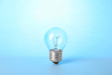 New modern lamp bulb on light blue background