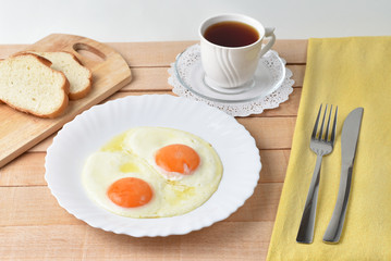 Fried eggs on rustic background