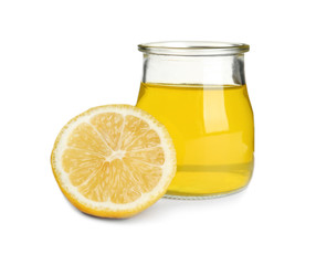 Piece of lemon and tasty jelly dessert in glass jar on white background