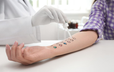 Patient undergoing skin allergy test at light table, closeup