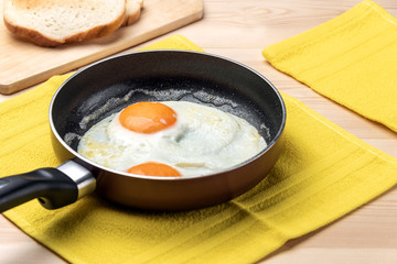 Fried eggs on rustic background
