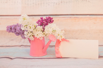 Lilac flowers bouquet in watering can