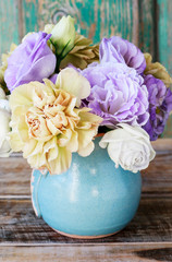 Bouquet of carnations and eustoma flowers in ceramic pot