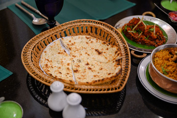 Chapati breads in basket with indian food