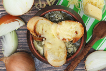 A ceramic pot with French onion soup