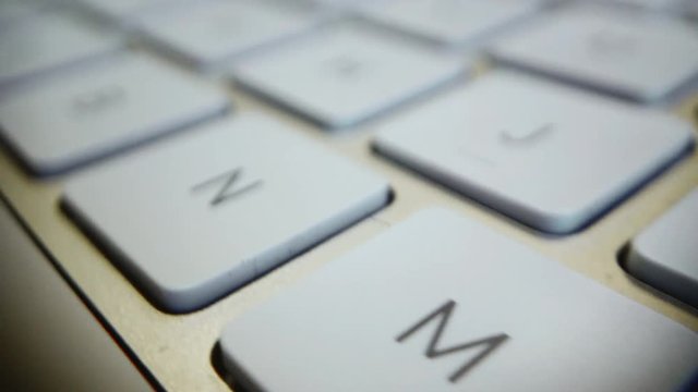 A macro shot of random letters on a simple looking keyboard. Shot in 4k 60 fps.