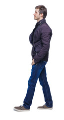 Naklejka premium Side view of going handsome man in jeans and jacket.